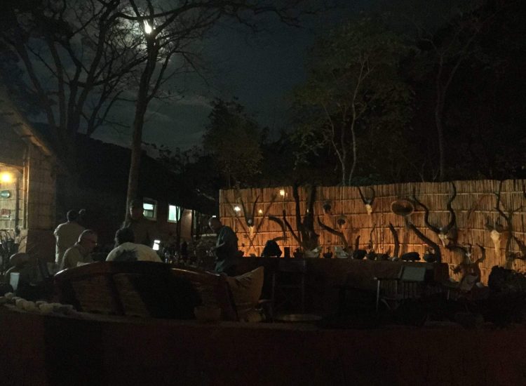 Mozambique Hunting Night scene at Graham Sales Safaris with outdoor seating and moonlit sky.