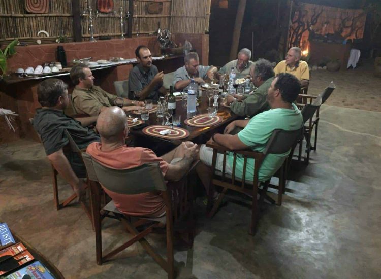 Mozambique Hunting Group of people having a discussion during a dinner at Graham Sales Safaris.
